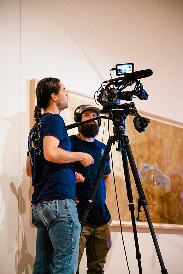 UNCG videographers David Row and Grant Gilliard stage a scene through a camera.
