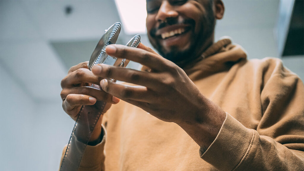 UNCG photography student Antonio Bailey works with a spool.