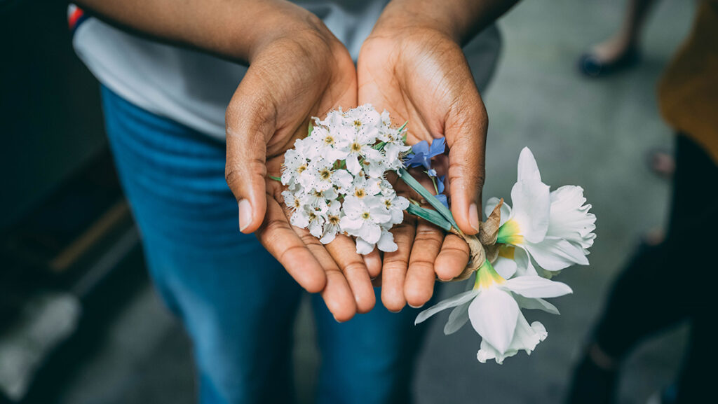 UNCG student Amara Udeh holds flowers collected from campus.