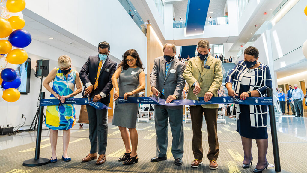 UNCG administrators cut the ribbon for the new Nursing Instructional Building.