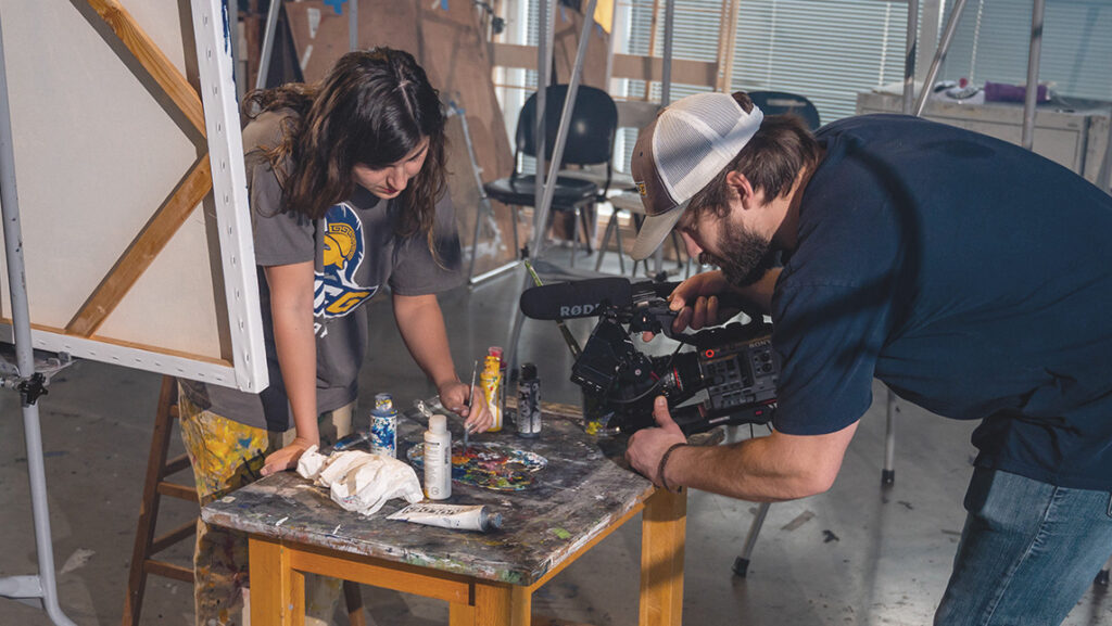 UNCG videographer Grant Evan Gilliard gets a close-up shot of art student Natalie Robinson.