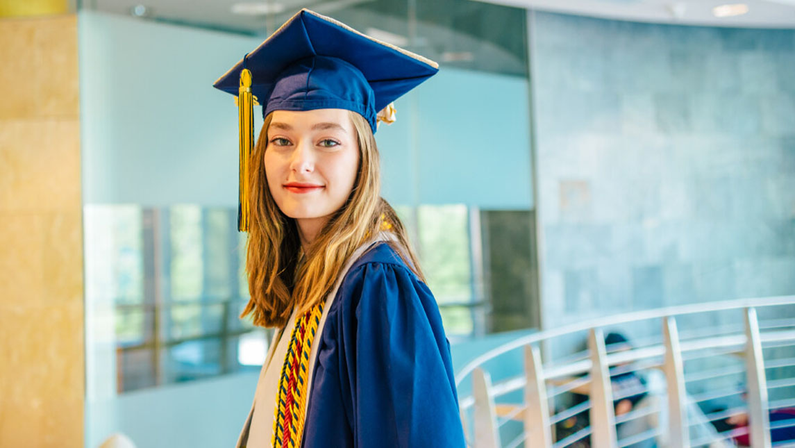 Hannah Ward poses in a cap and gown