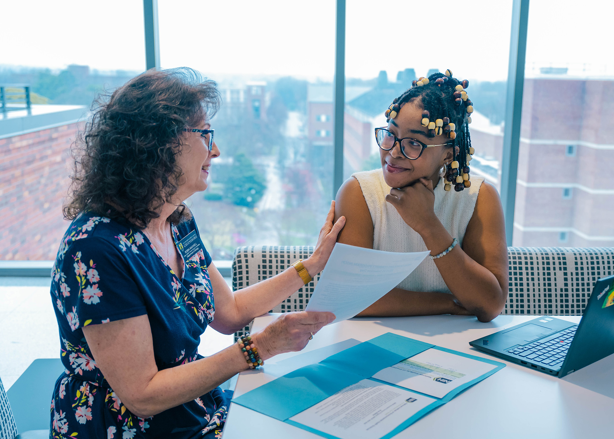 Pre-vet student meets with advisor in Nursing Instructional Building.