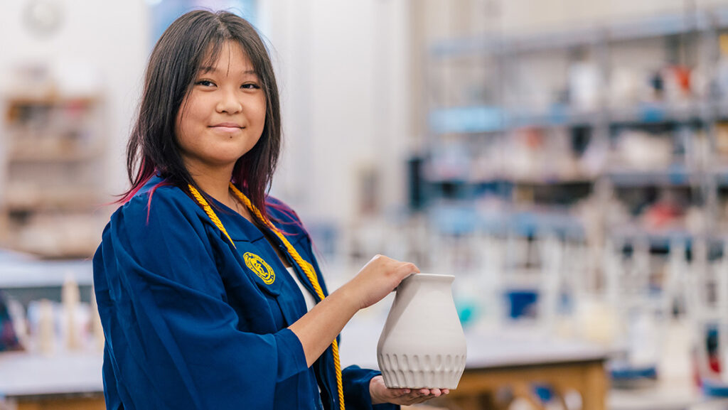 UNCG student Tiffany Tan holds a vase