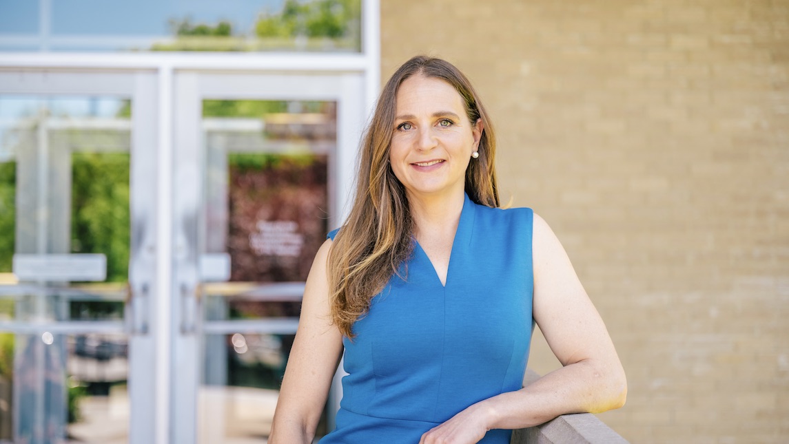 Brianna poses in front of UNCG's BSBE school.