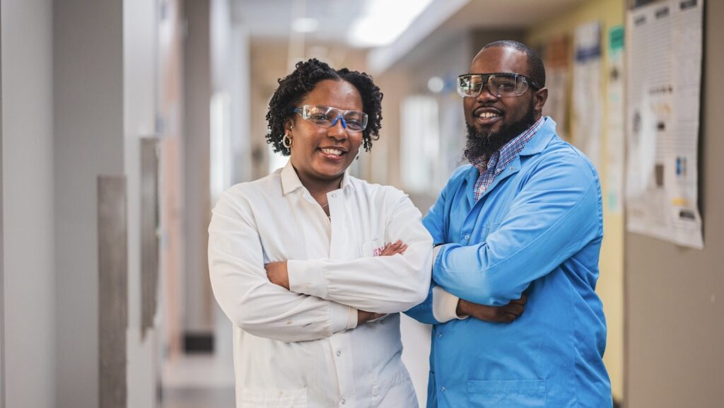 Eric and Selina Laws pose together in the hallway of the UNCG JSNN school.