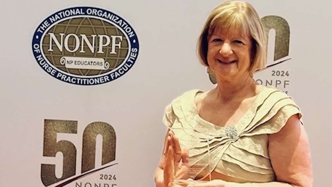 Laura Kennedy Malone holding her NONPF award.