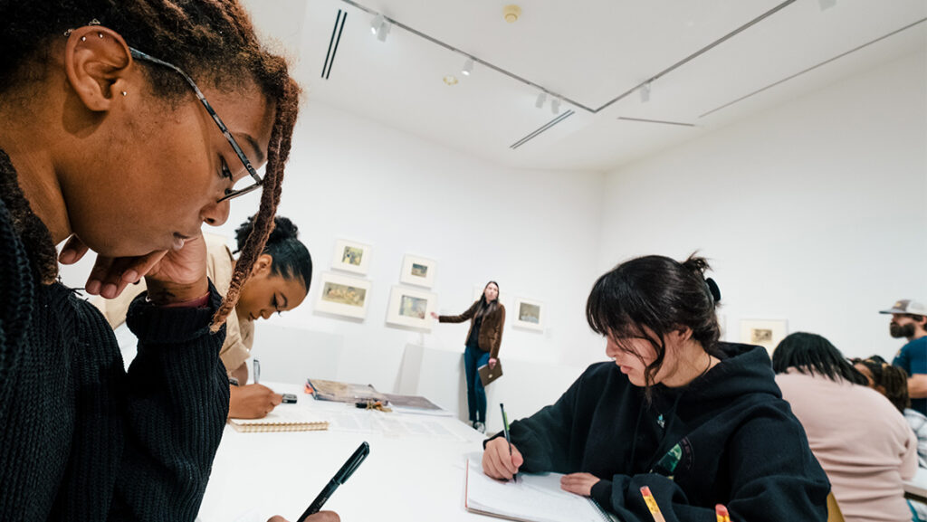 UNCG students sit at tables sketching at Weatherspoon Art Museum.