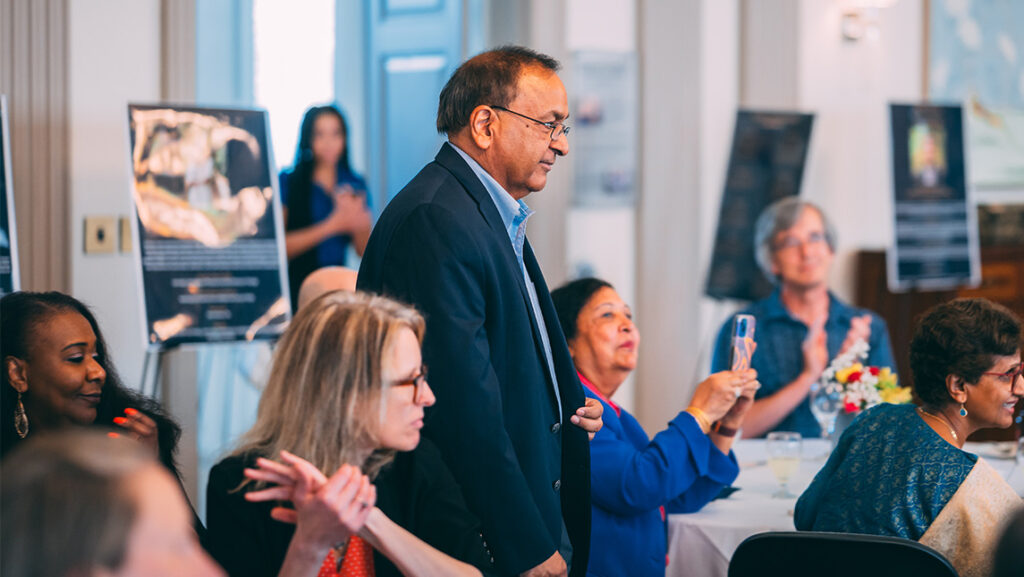 Dr. Sat Gupta walks up to receive his UNCG faculty award.