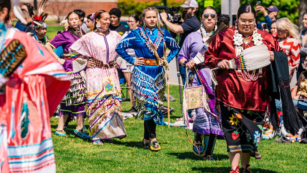 Native American dancers line up for UNCG powwow, including Mohawk member Chloe Thompson.