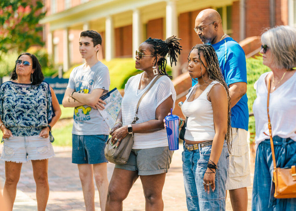 Parents and prospective students attend a campus tour.