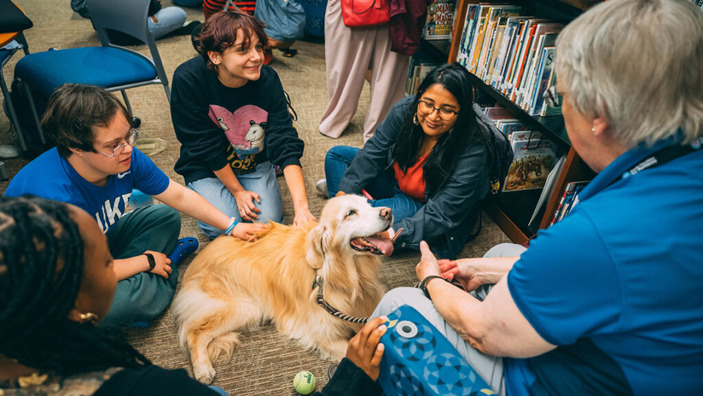 Therapy dogs visit with UNCG students.