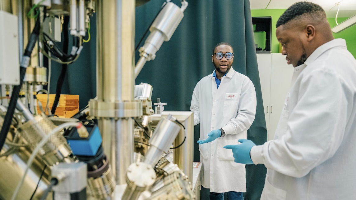 Two JSNN students talk about a project in the UNCG lab.