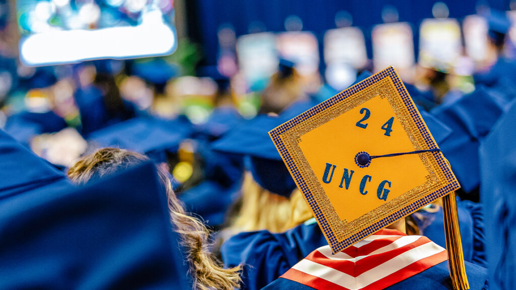Graduation mortar board with 24 UNCG written on it