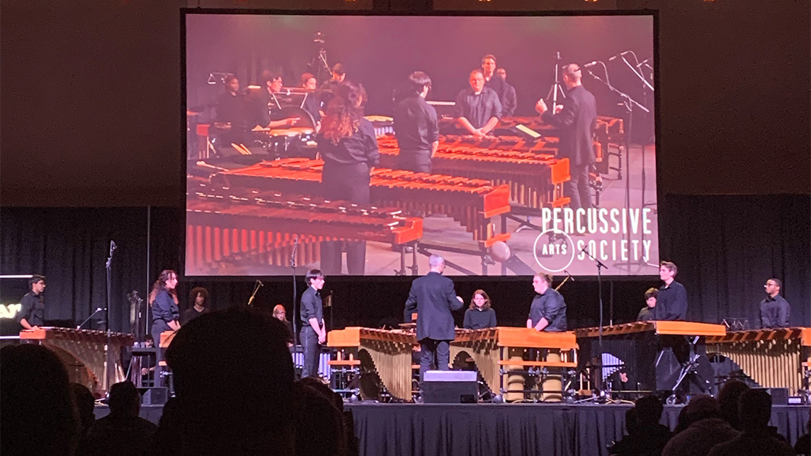 The UNCG Percussion Ensemble performs onstage.