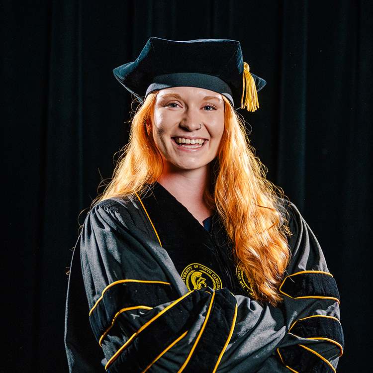UNCG 2024 grad Lexi Hoopman in her cap and gown.