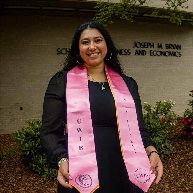 UNCG 2024 grad Pooja Tadepalli holds up her graduation stole.