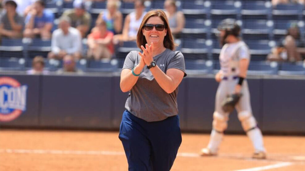 UNCG softball coach Janelle Breneman claps on the field.