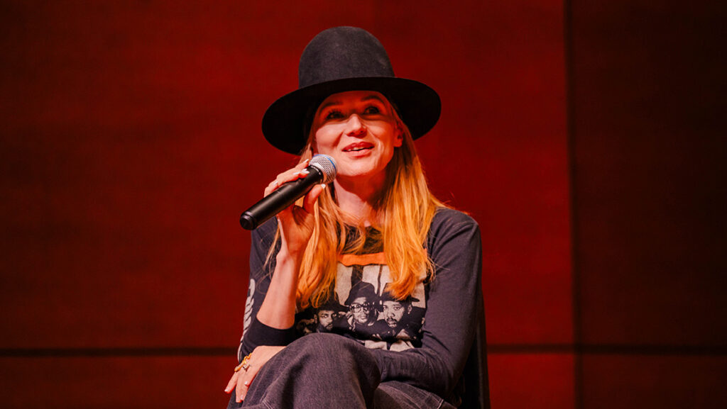 Artist Jewel speaks into a microphone at UNCG.