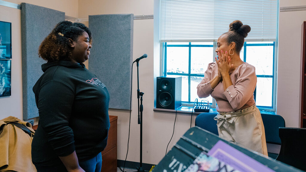 UNCG professor Janinah Burnett goes through singing exercises with a student.
