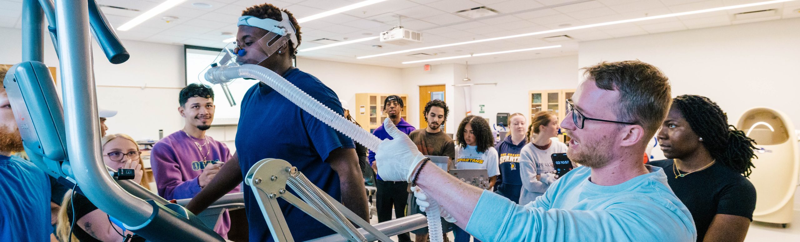 Students and professor in a lab.