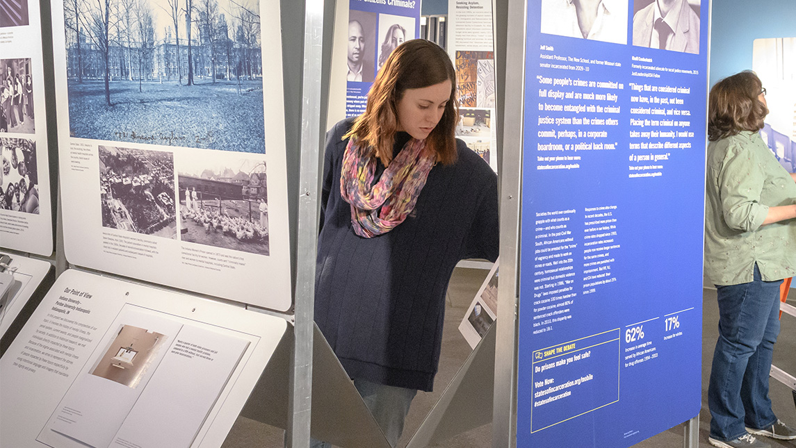 A UNCG student puts together panels for a museum exhibit.