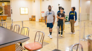 UNCG students look at the historic sit-in counter at a museum.