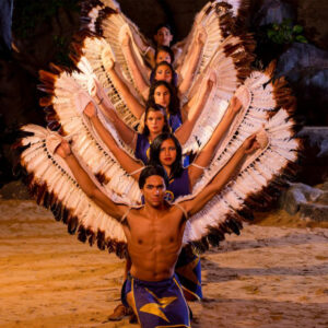 Performers wear Cherokee dress during nighttime performance.