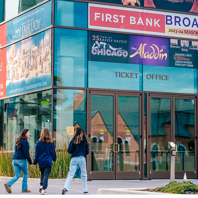 Tanger Center ticket office entrance with three students walking in.