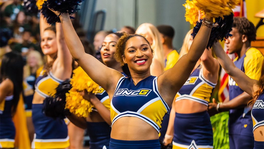 A UNCG cheerleader waves her pompoms.