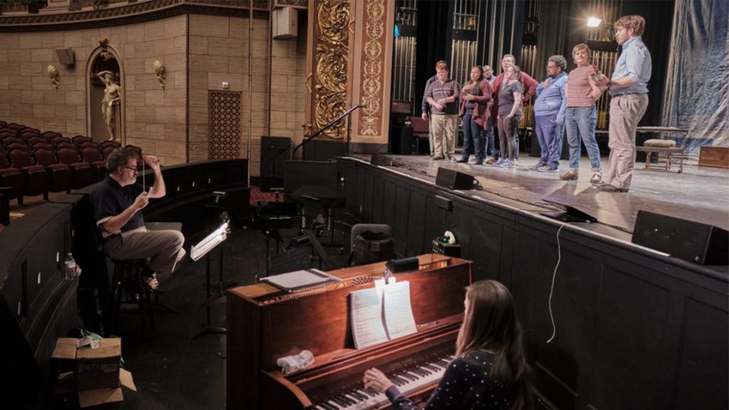 Students sing on the stage at UNCG.