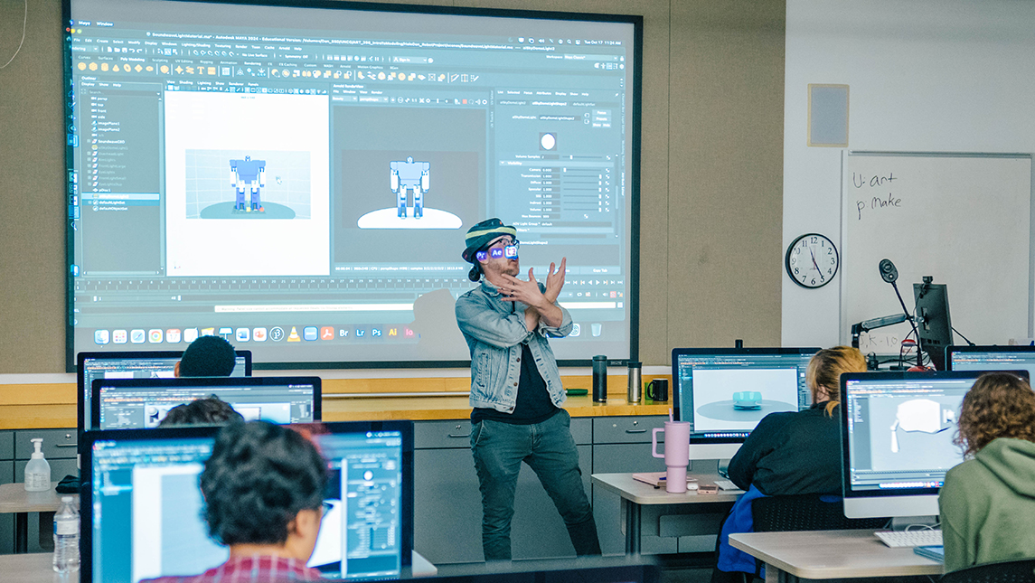 an instructor in front of a screen in the animation lab