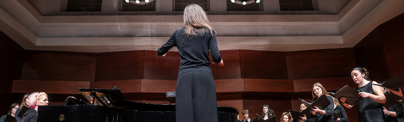 Choral conductor leading the university choir
