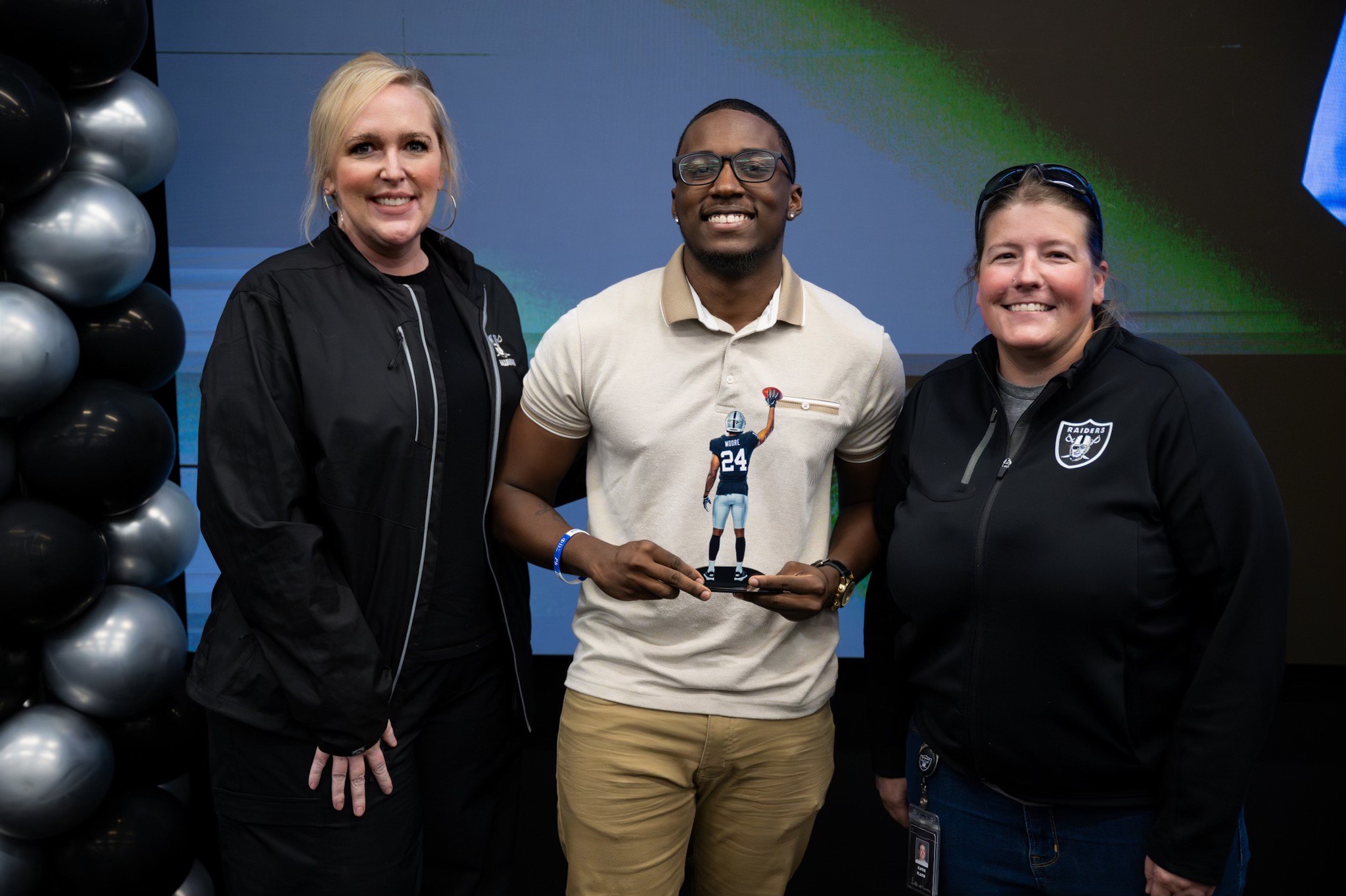 Dr. Lindsey Sanders, left, with Desmond Moore and Katie Flath at the Raiders compound. 