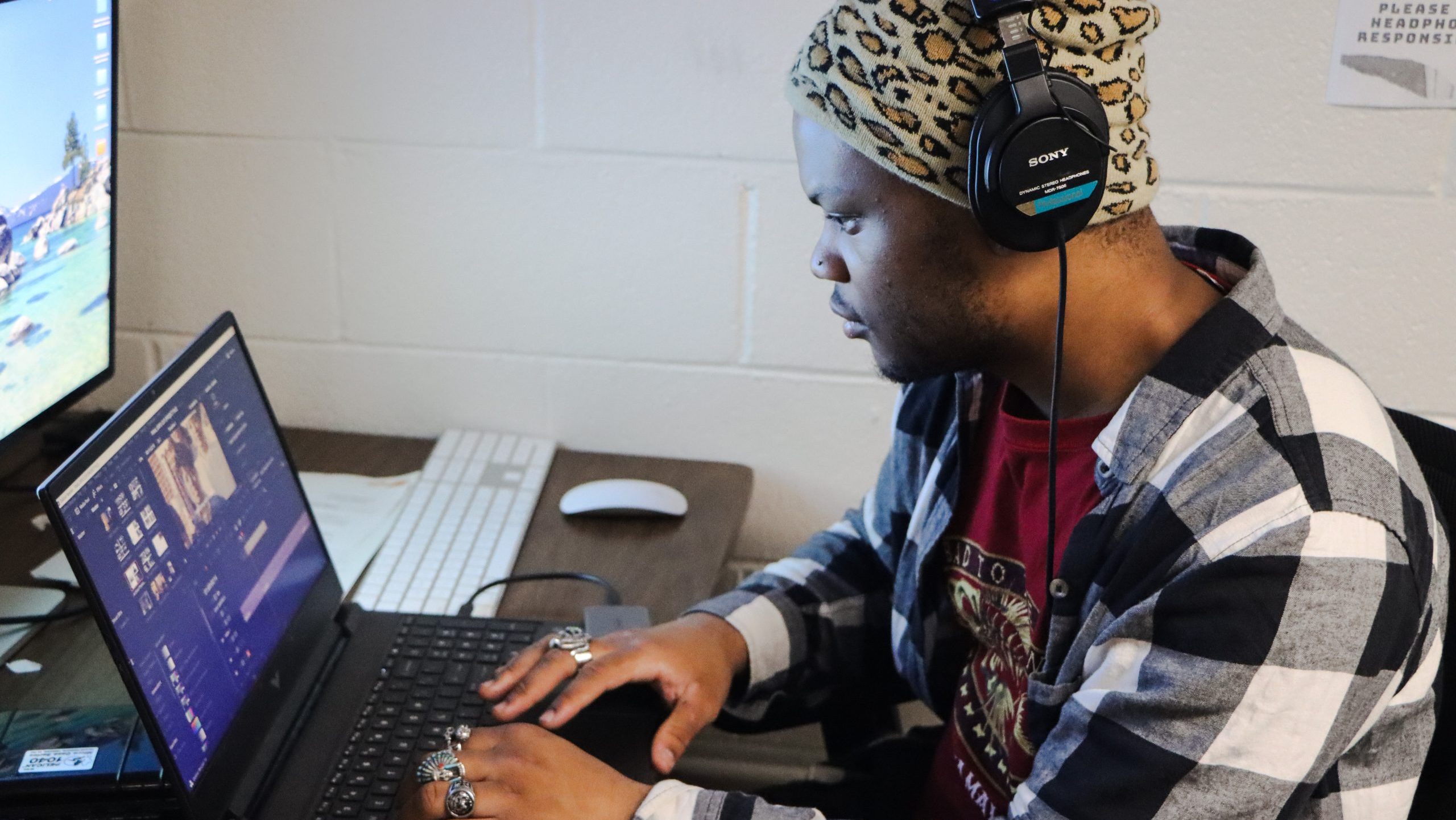Cole Smith wearing headphones works at a laptop.