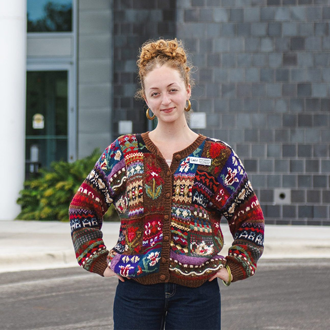 Woman stands in front of an art museum.