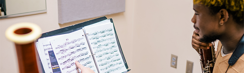 music teacher with student and sheet music
