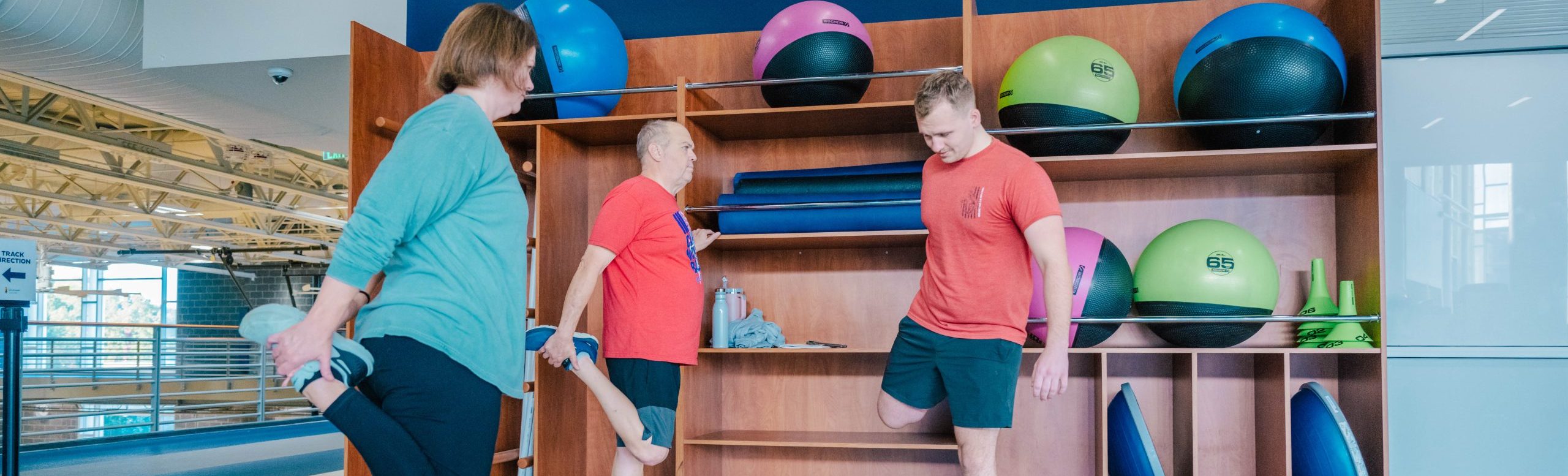 People stretch in a gym.