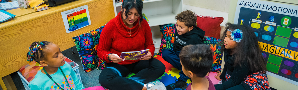 Kenia Perez-Melchor, a UNCG student teacher, reads with elementary students