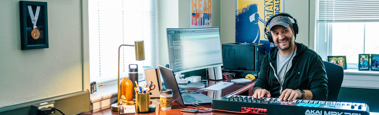 A music professional sitting at their desk.