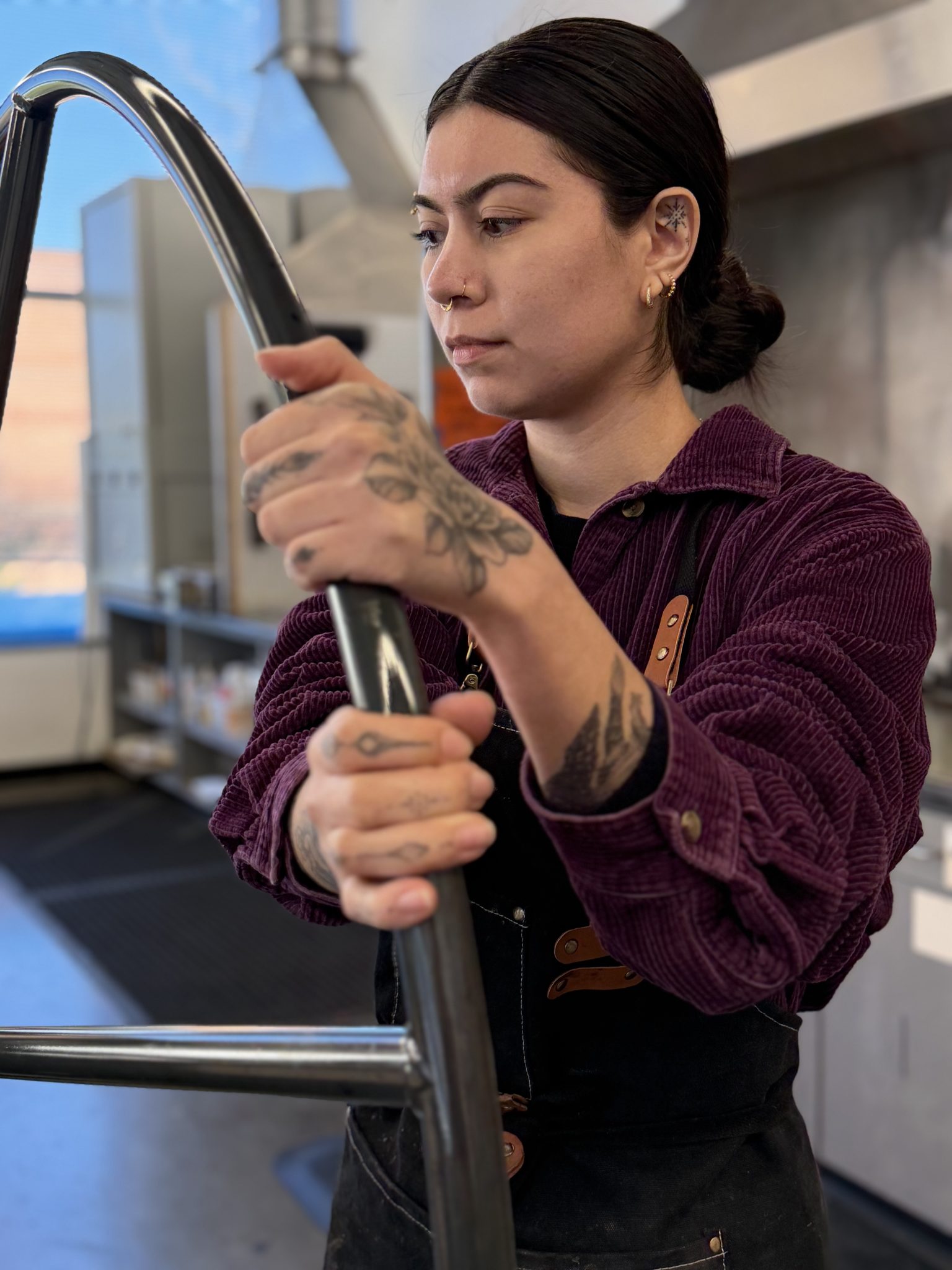 Sofia Aguilar working with materials in an art studio.