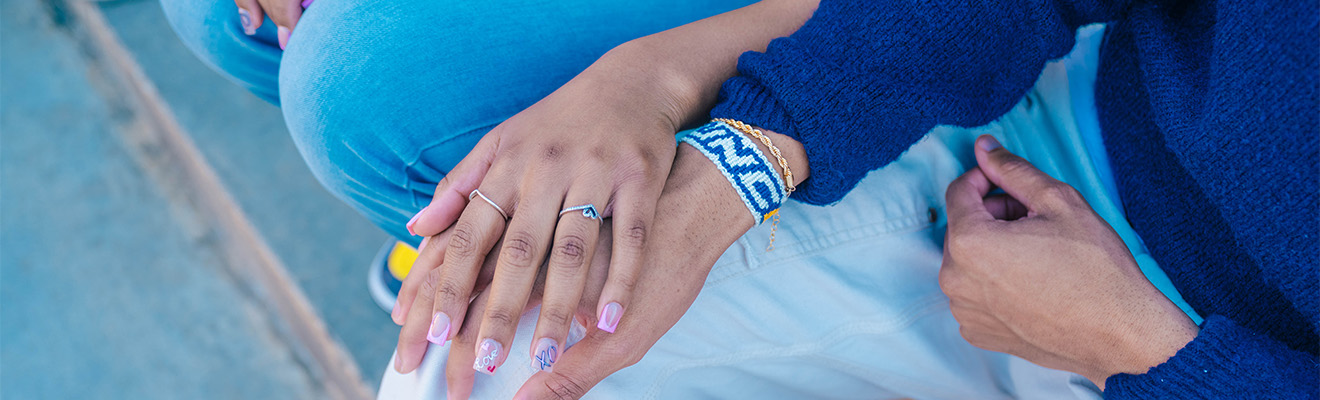 Close up on a couple holding hands.