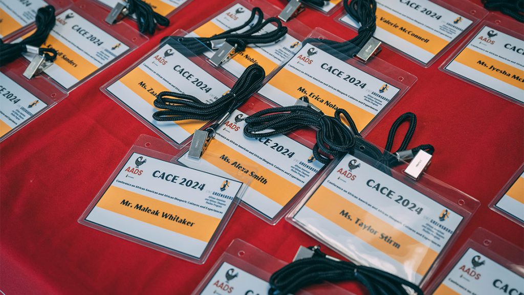 Name tags for the UNCG CACE Conference sit on a table.