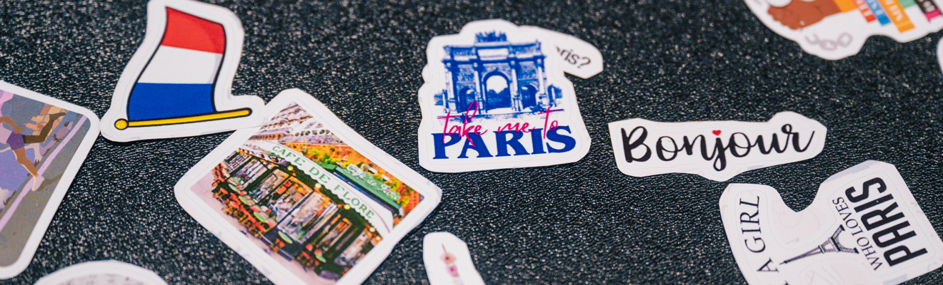 A selection of stickers with French words and images lay flat on a table.