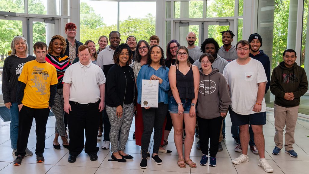 Students and staff with UNCG Integrative Community Studies take a group photo.