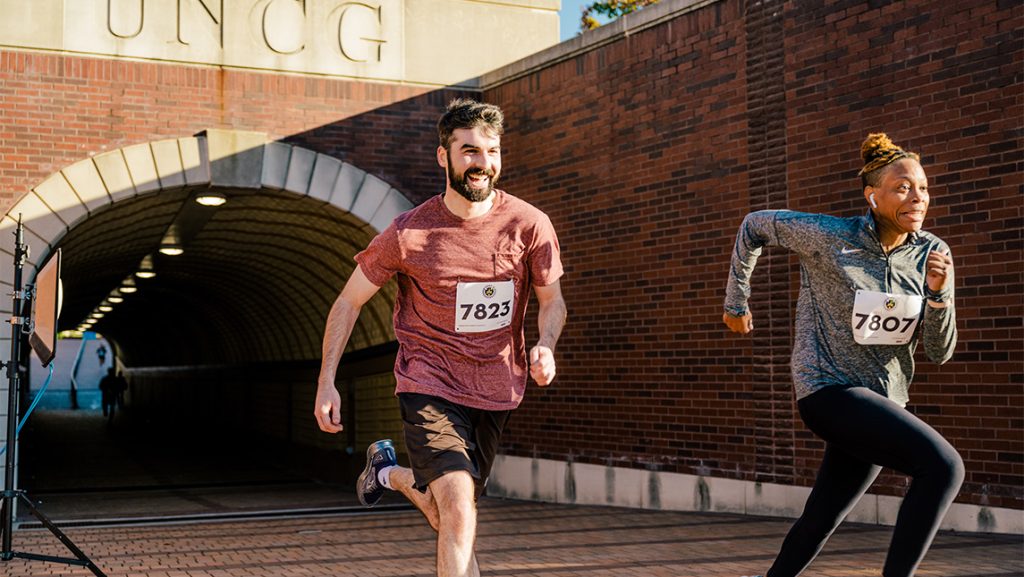 Runners of a 5k exit the UNCG tunnel.