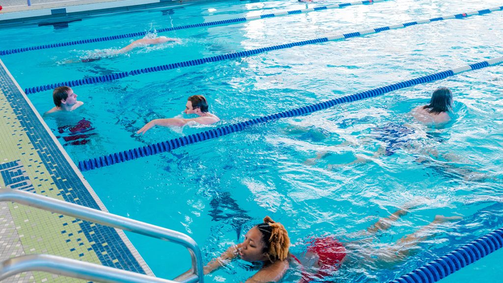 UNCG students swim in the Natatorium.