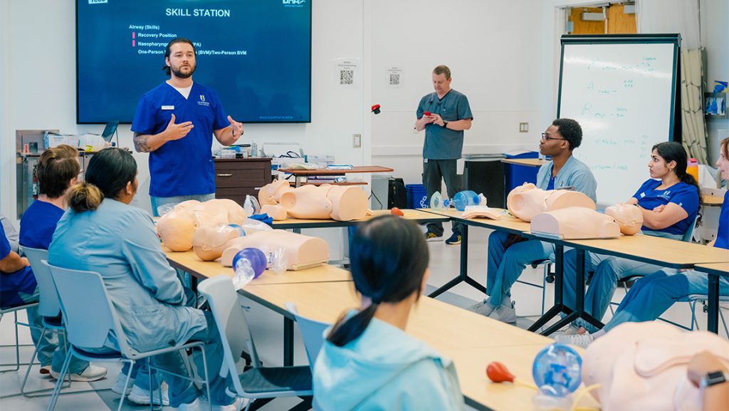 A UNCG nursing student leads a class about breathing assistance.