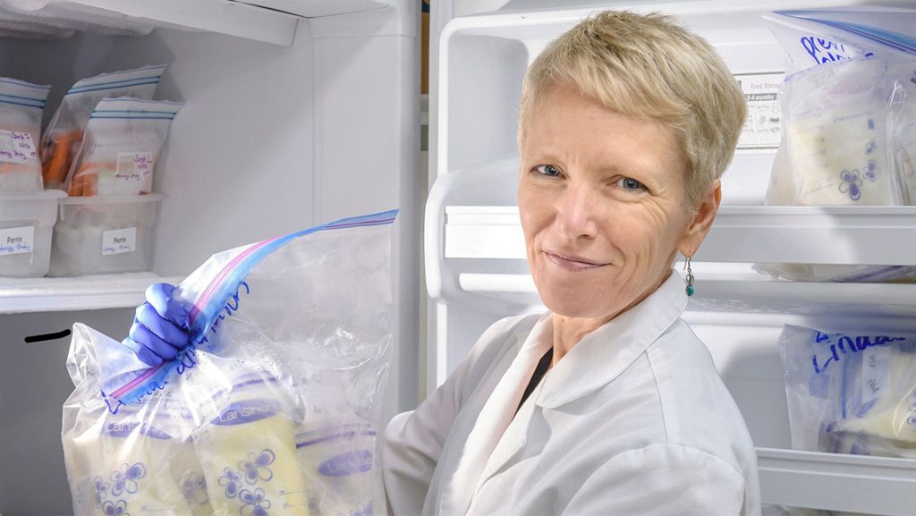 UNCG's Dr. Maryanne Perrin holds up a bag of breastmilk.