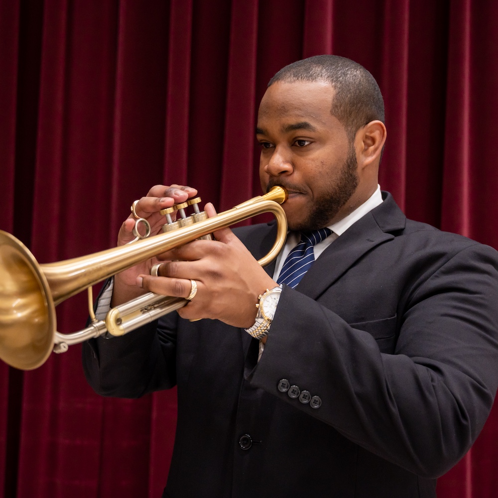 Quinton Parker plays a trumpet.
